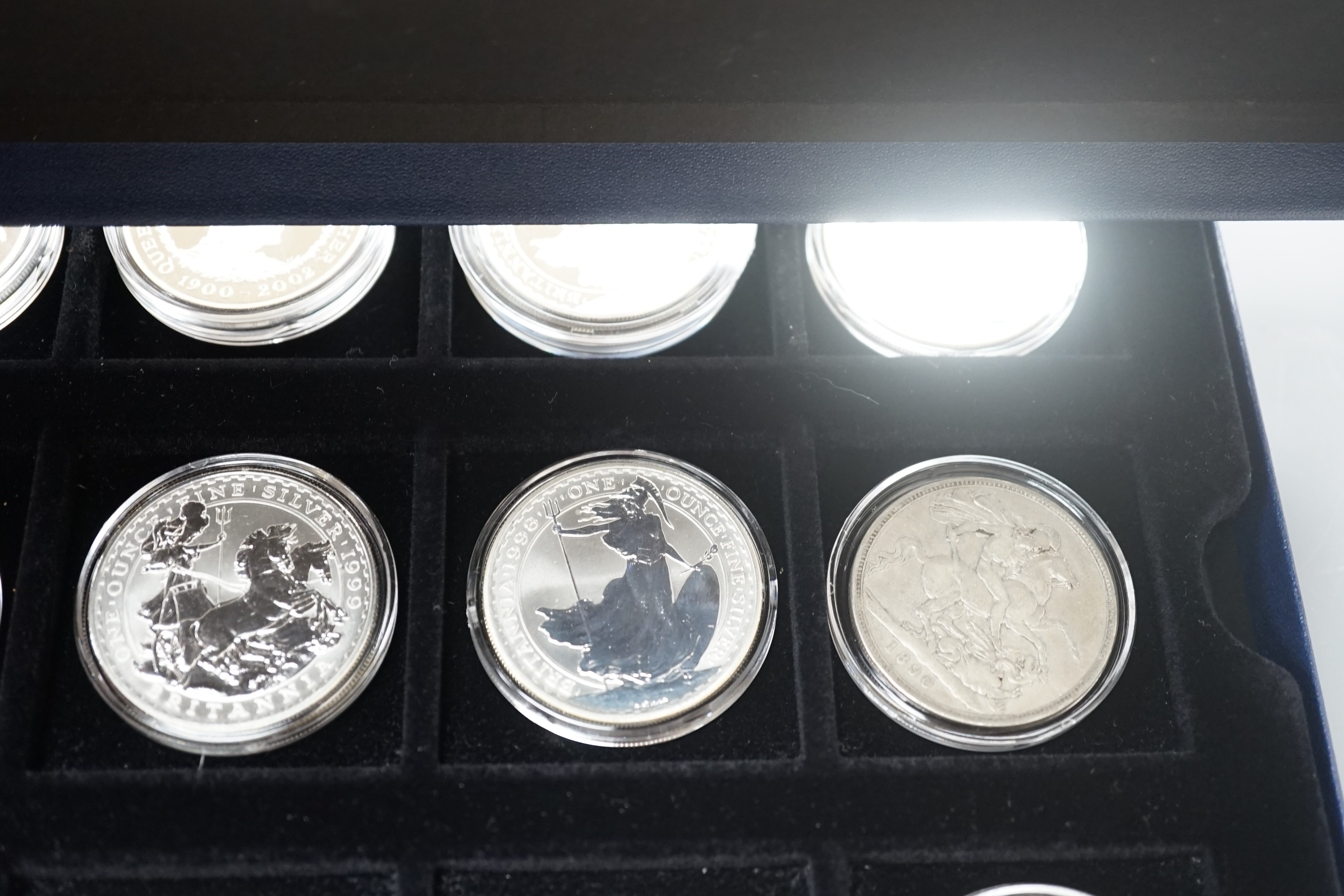 A group of coins including 1898 British Trade One Dollar, Royal Mint UK two QEII five shillings, 1935 crown, 1890 crown, silver proof coins - five 1oz. silver Britannia £2 coins 1998-2000, 2003, 2004, 2002 Queen Mother £
